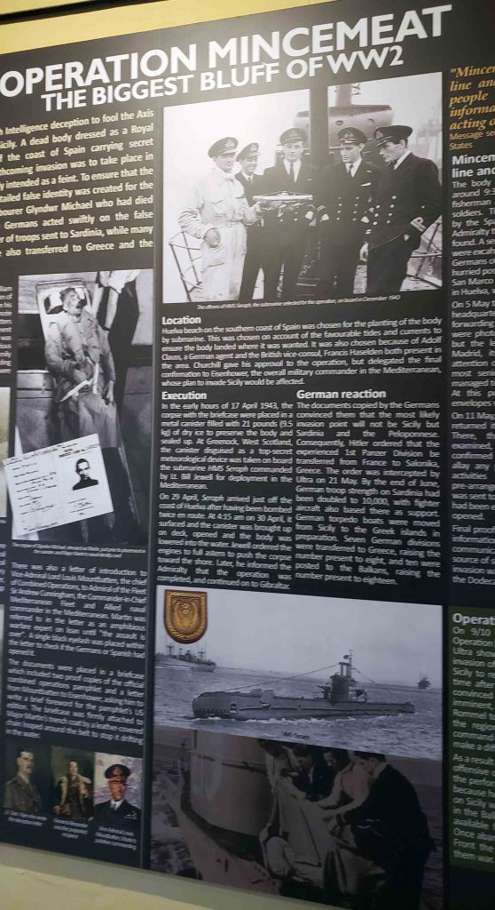Informative display about Operation Mincemeat, an intelligence operation during World War II aimed at deceiving Axis forces. Includes photos, text detailing the plan, execution, German reactions, and strategic significance.